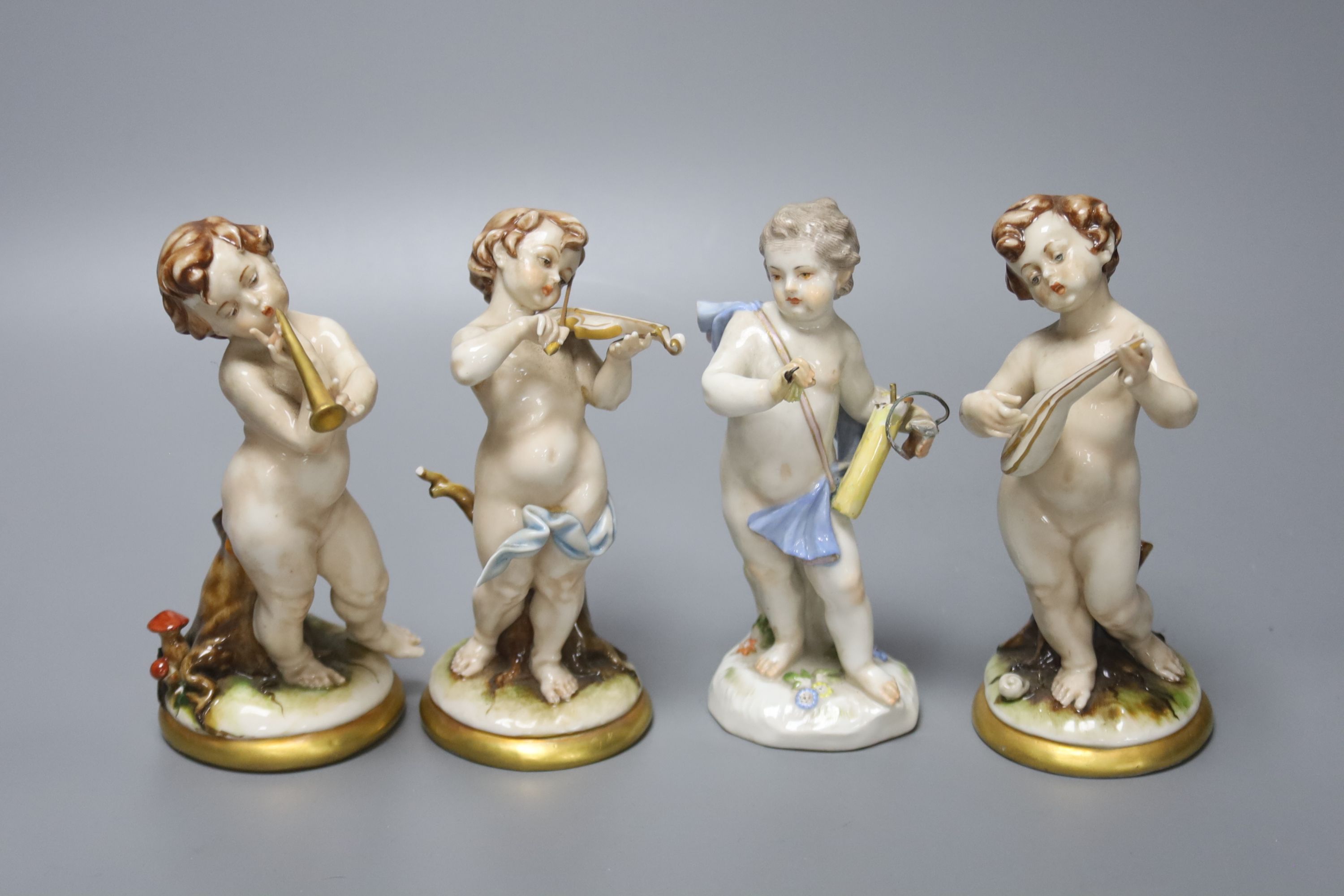 A Meissen porcelain figure of a cherub together with three Continental porcelain cherubs, height 14cm